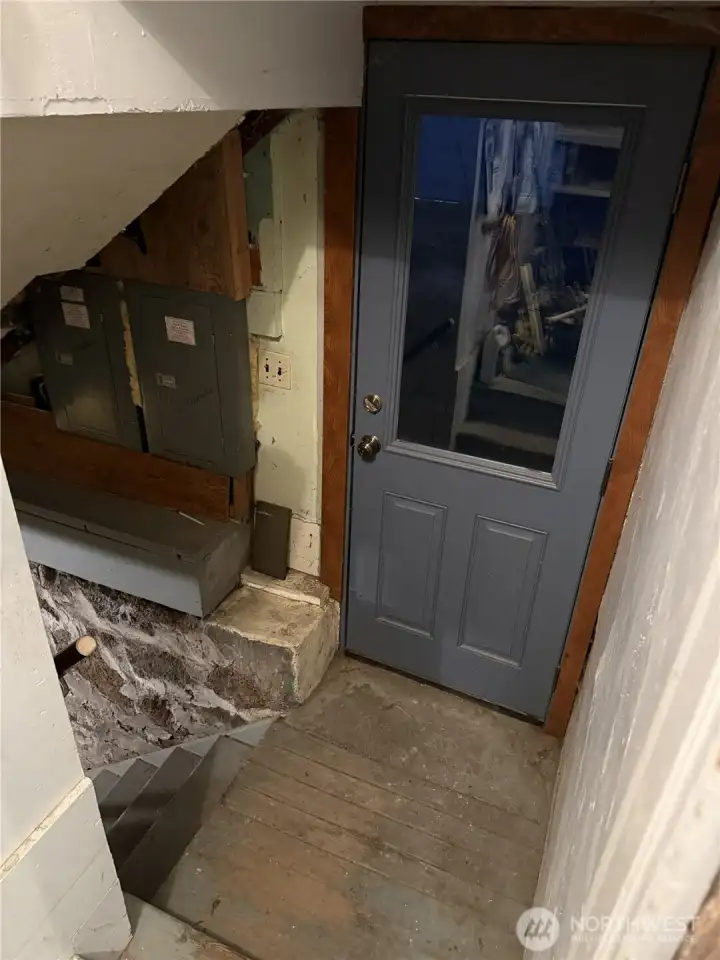 From the Kitchen eating area heading down to the basement; blue door is an exterior door to the basement