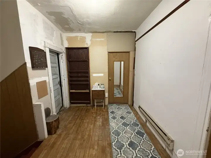 View from landing of 2nd floor - room behind the door with the mirror is a full bathroom. The room behind the blue door is a small room that can be used as a bedroom but was used as an office. Behind the brown door leads down a hall to the half bath, an area that was being used as a bedroom and that room has the access to the attic.