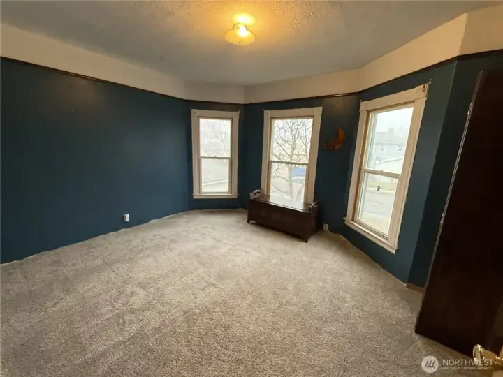 Bedroom behind the door with the white board