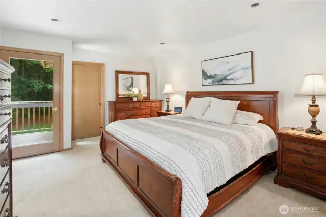 Peaceful primary suite offers a deck to retreat to and enjoy the sunset after a long day!