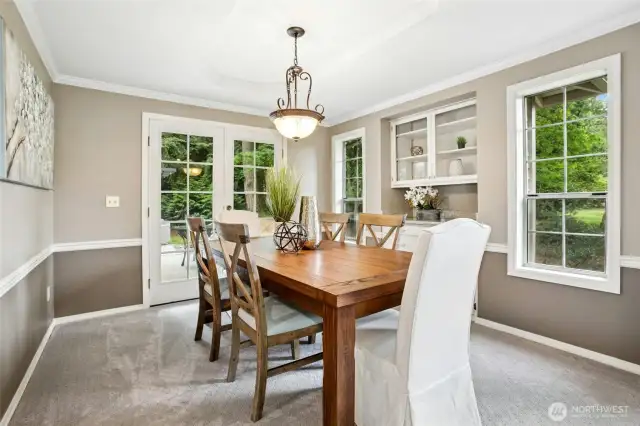 Elegant dining room great for entertaining with built in cabinets.