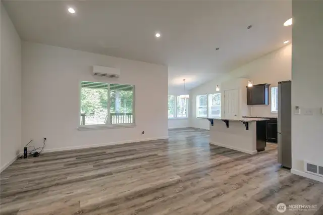 Entering the home via the front door, you step into the open concept living space of the great room, kitchen, and dining room.