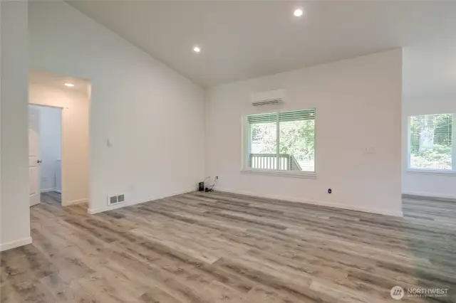On the opposite side of the great room, you will find the laundry room and entrance to the garage, along with the primary suite.