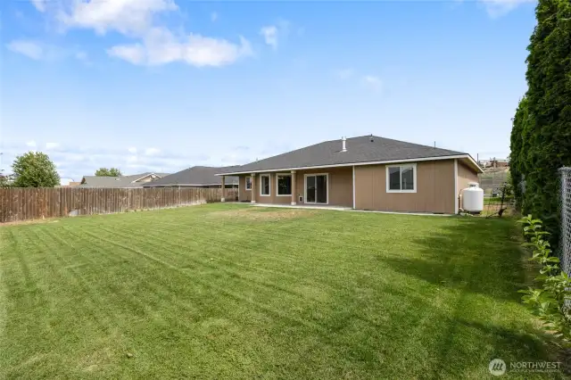 Backyard is grassed with underground sprinklers