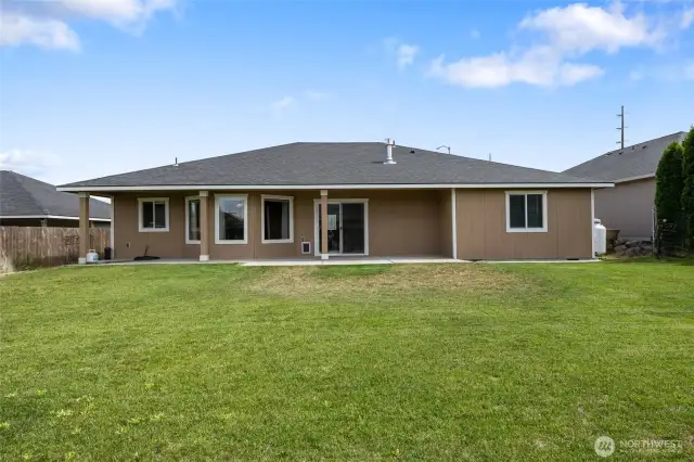 View of the back of the house showcases all of the windows and quality construction