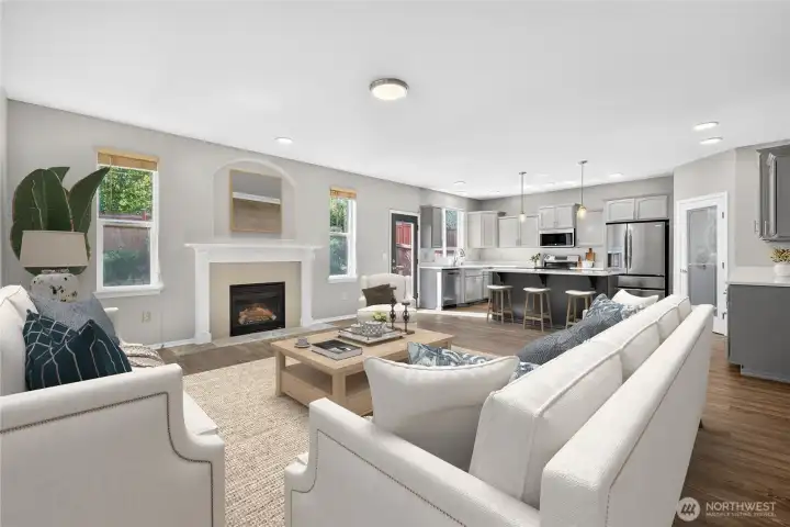 Spacious living area featuring gas fireplace, open layout, and eat-in kitchen (virtually staged)
