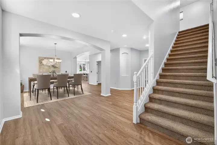 Grand entrance and view into dining area (virtually staged)