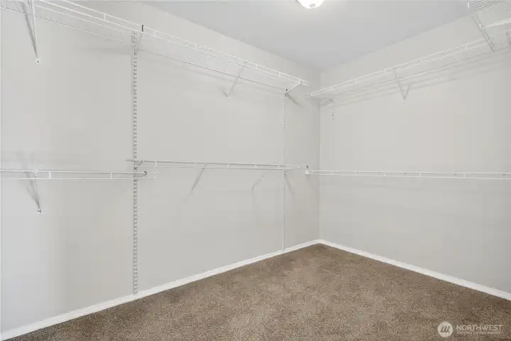 Spacious walk-in closet off ensuite with ample shelving and hanging space