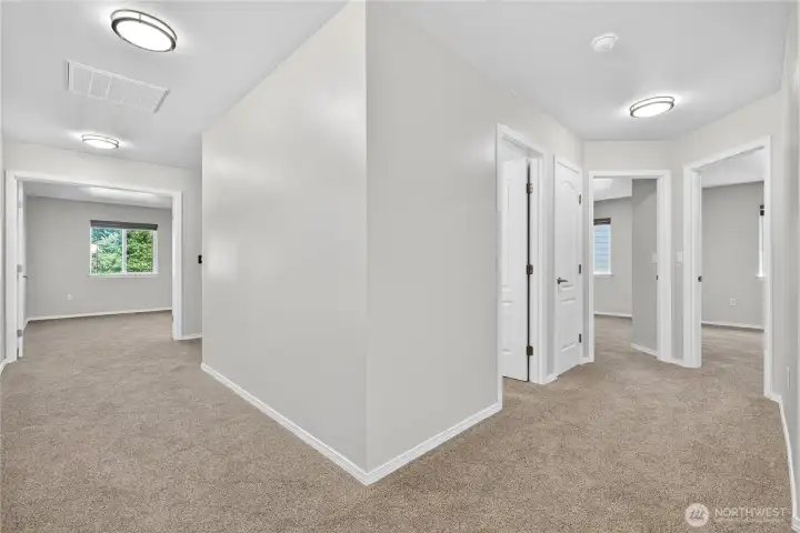 Alternate upstairs hallway view highlighting the layout of secondary bedrooms, shared bathroom, and versatile bonus room down the hall