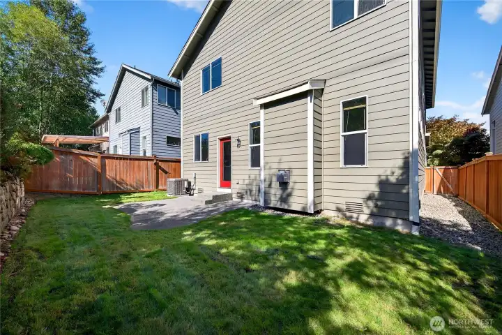 Spacious backyard featuring side yards with gates on both sides, offering privacy & easy access