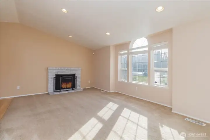 Open and bright living room with high ceilings and large windows.