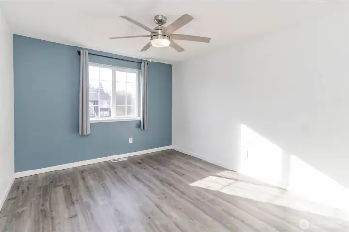 Bedroom 2 with new laminate flooring and lighting.
