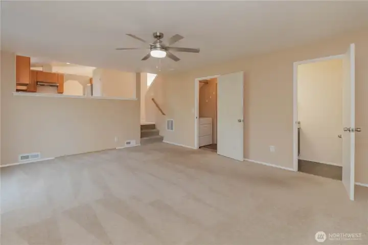 Large open family room downstairs with slider walk-out to deck, access in laundry room to garage and additional half bathroom.