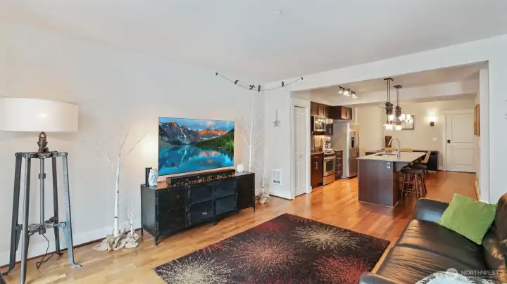 Living room with floor to ceiling windows, refinished walnut floors.
