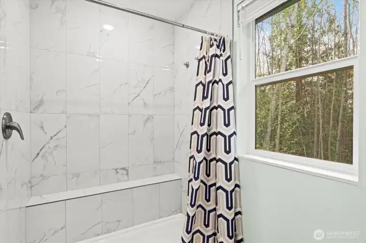 Floor-to-ceiling tile in the primary bathroom.