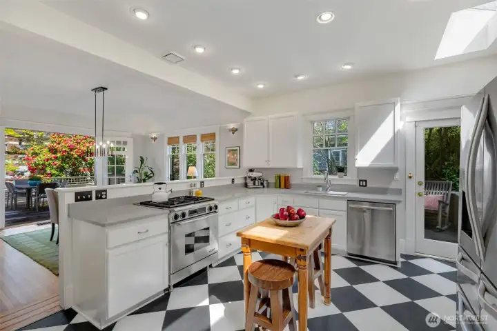 The updated kitchen features stainless appliances including gas stove.