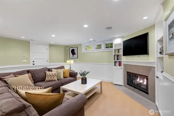 Family/media room with gas fireplace and 7.1 surround sound.