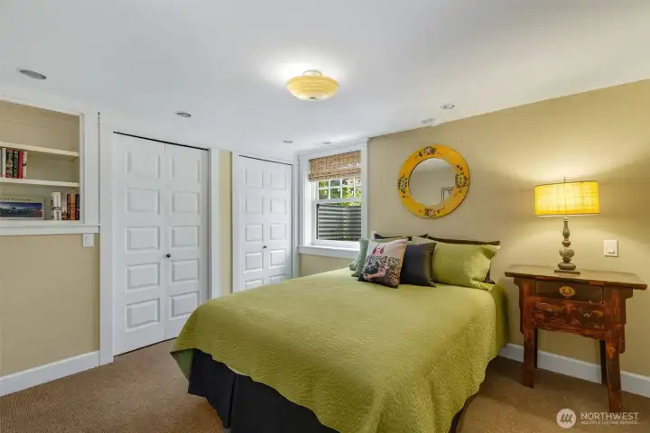 Large lower level bedroom with walk-in closet and adjacent bath.