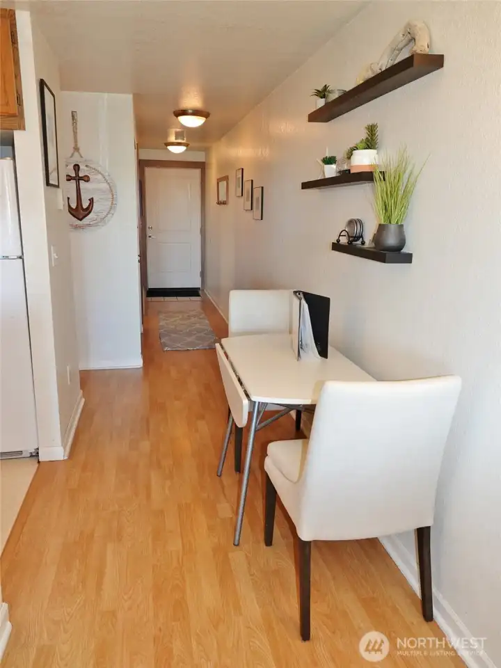 Dining Area leading to the hallway to the entry and bedroom.