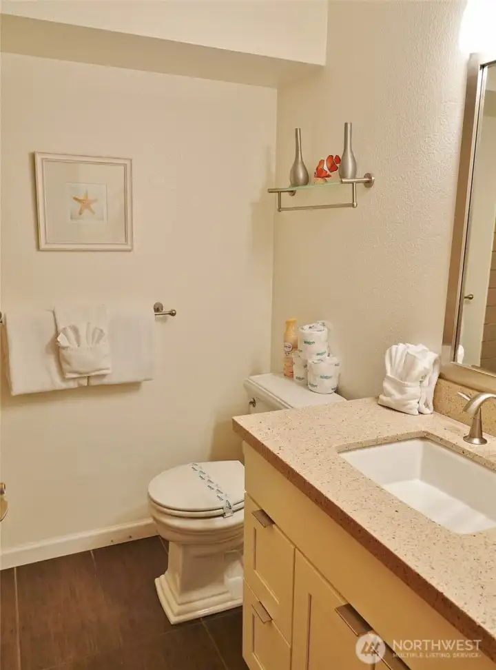 Nicely appointed bathroom w/ quartz vanity.
