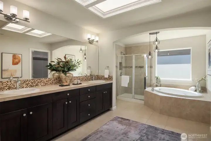 Primary ensuite bathroom double sinks and spa bath.