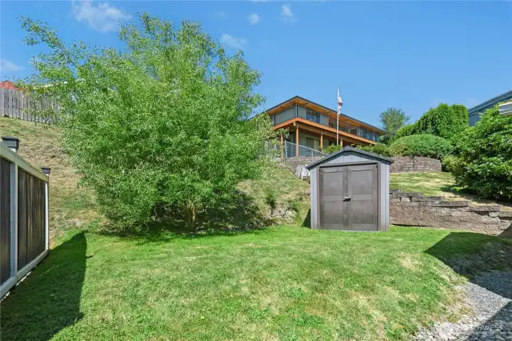 Large yard with garden shed. Large yard with garden shed.