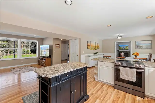 Large kitchen with lots of storage with Granite and hardwood flooring