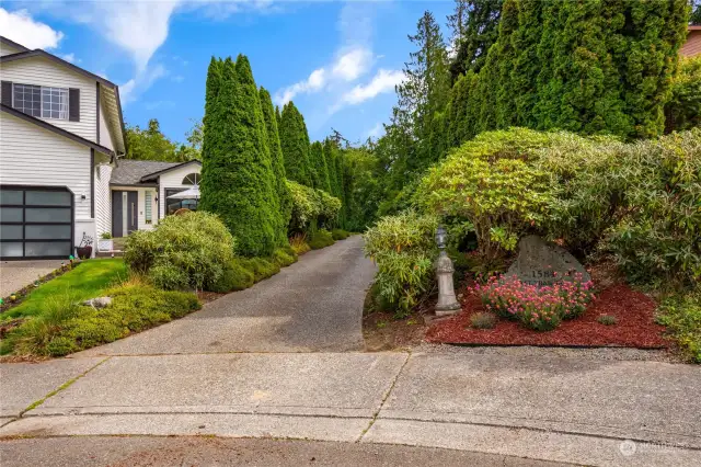 Entrance to driveway from street behind planter circle