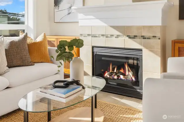 Tiled gas fireplace is a beautiful and inviting focal point. Cozy up!