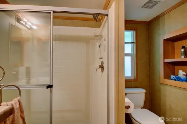 Full bathroom with shelving