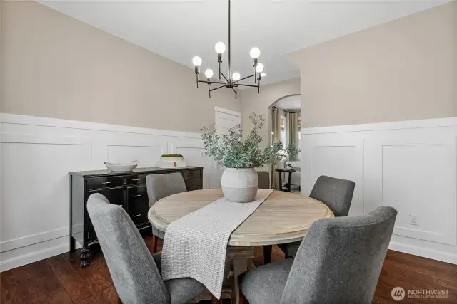 The addition of a modern light fixtures transforms this elegant room to a transitional modern space.  The classic panel moulding on the walls are timeless for additional depth and beauty.