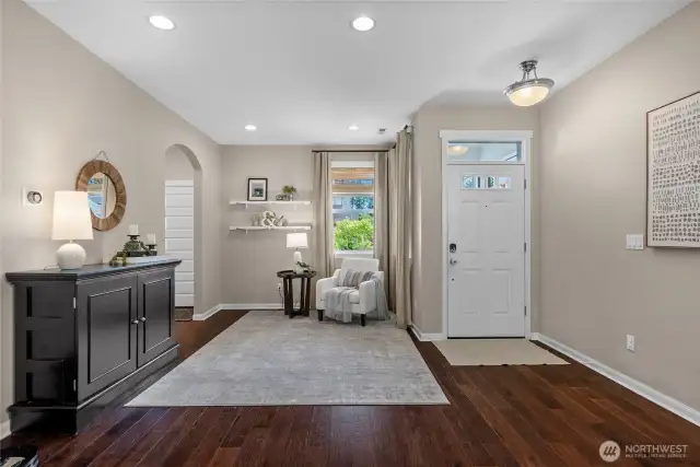 Beautiful engineered hardwood flooring flows throughout the main level, paired with soft, light tones for a warm and welcoming feel.