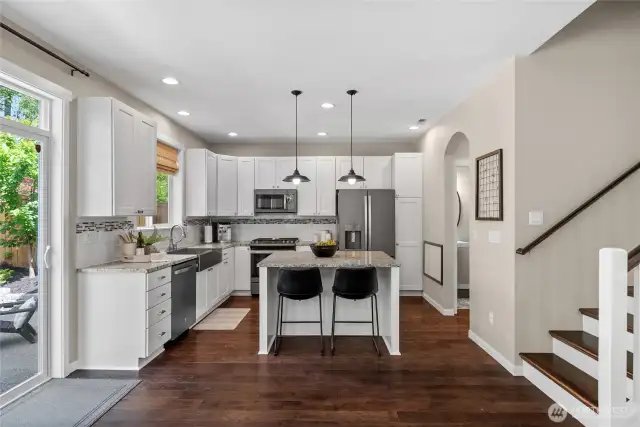You’ll love the elegant arched doorway leading to the dining room—perfect for effortless entertaining. Thoughtfully updated, the staircase now features new risers and treads, creating a seamless flow to the second level and reflecting the care of a meticulous homeowner.