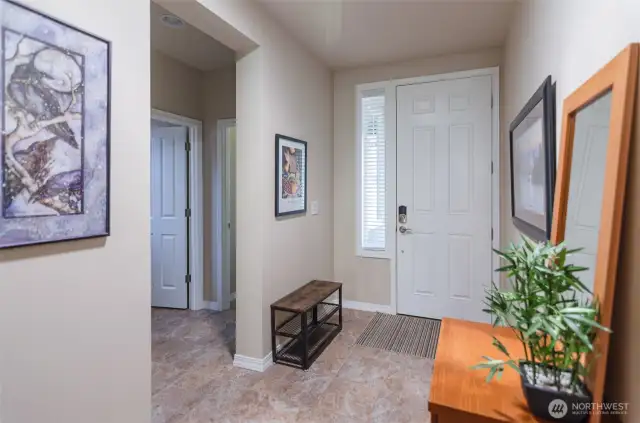 Inviting front entry Tiled floors through entry and guest bath to the left.