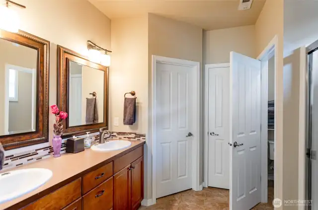 Primary bath has double sinks, large walk-in closet, a linen closet and private toilet area.