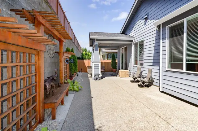 View of covered back patio.  Trellis detail, complete with sitting benches.