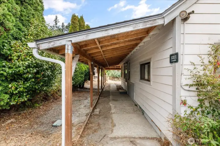 Front door is just ahead, under covered porch.
