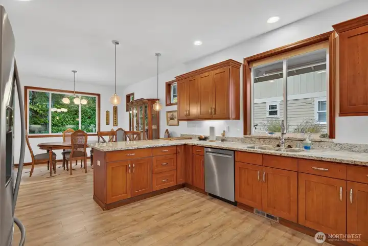 Large kitchen with ample storage and counter space; stainless steel appliances remain with the home.