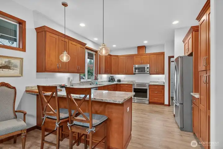 This kitchen is so welcoming with bar seating for snack time or for the kitchen helpers. Lots of room for the cook of the home