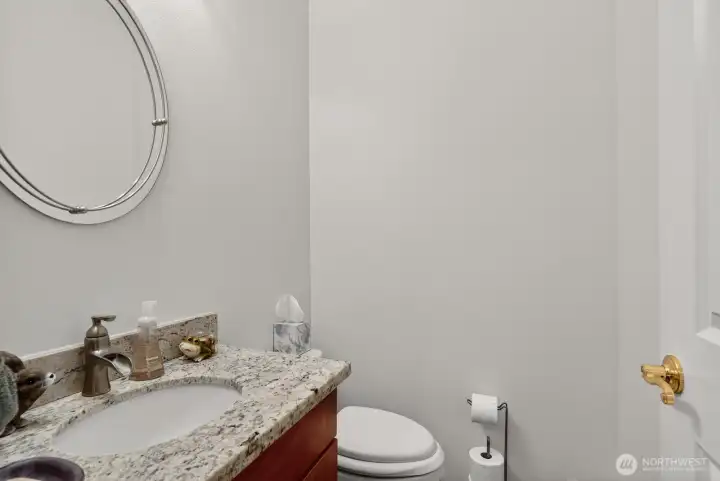 The powder room is in the utility room just off the garage