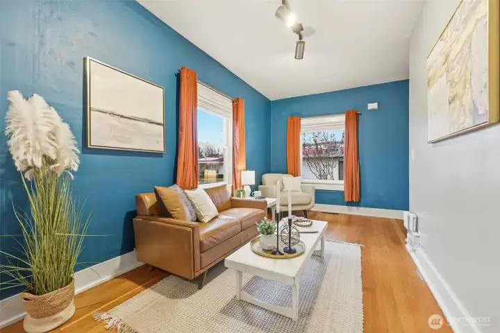 Cozy living room with high ceilings and hardwood floors
