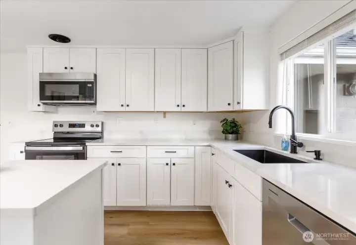 Kitchen has gorgeous new luxury vinyl plank flooring