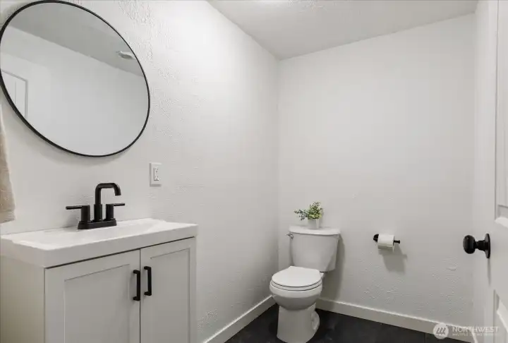 Bedroom 2's 1/2 bath has new vanity and new modern vinyl tile flooring