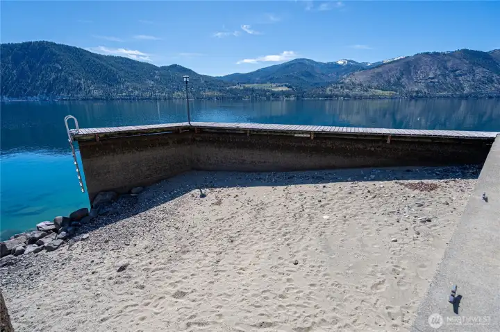 Protected Sandy Cove - photo is from low lake level. This is sandy swim area in Summer. Dock has space to tie jet skis