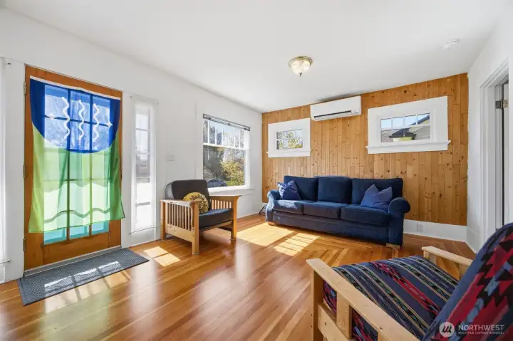 Once inside you will notice the southern sunlight streaming in on the gorgeously refinished original fir floors with the concentric rectangular pattern.