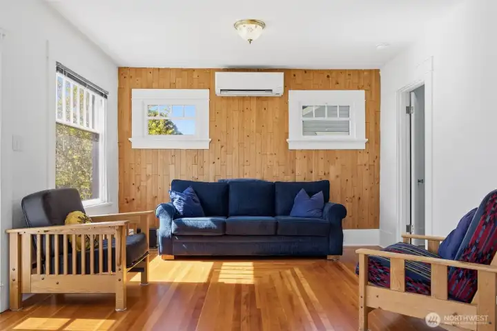 The living room has a lovely wood accent wall that has the fairly new mini-split heating and cooling system.