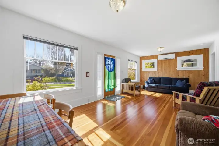 Looking across the dining area toward the front entry and the living room beyond.