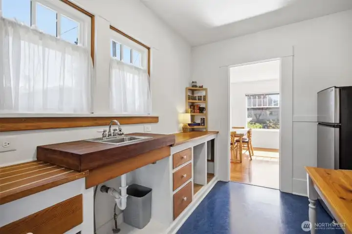 The kitchen has been refinished and the original counters are now exposed! They even have putty in the grooves where the water would run back to the sink after washing dishes.