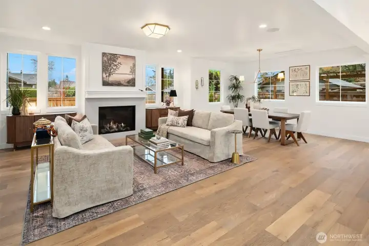 Stylish details include handsome fireplace flanked by symmetrical windows