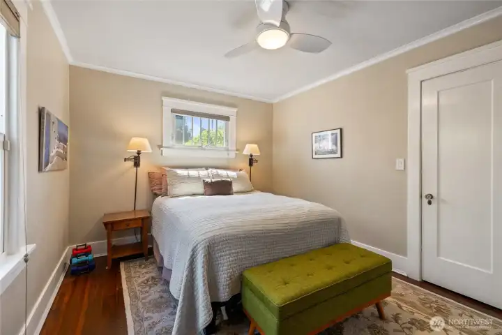 The bedroom gets great light, and notice the original glass doorknob.